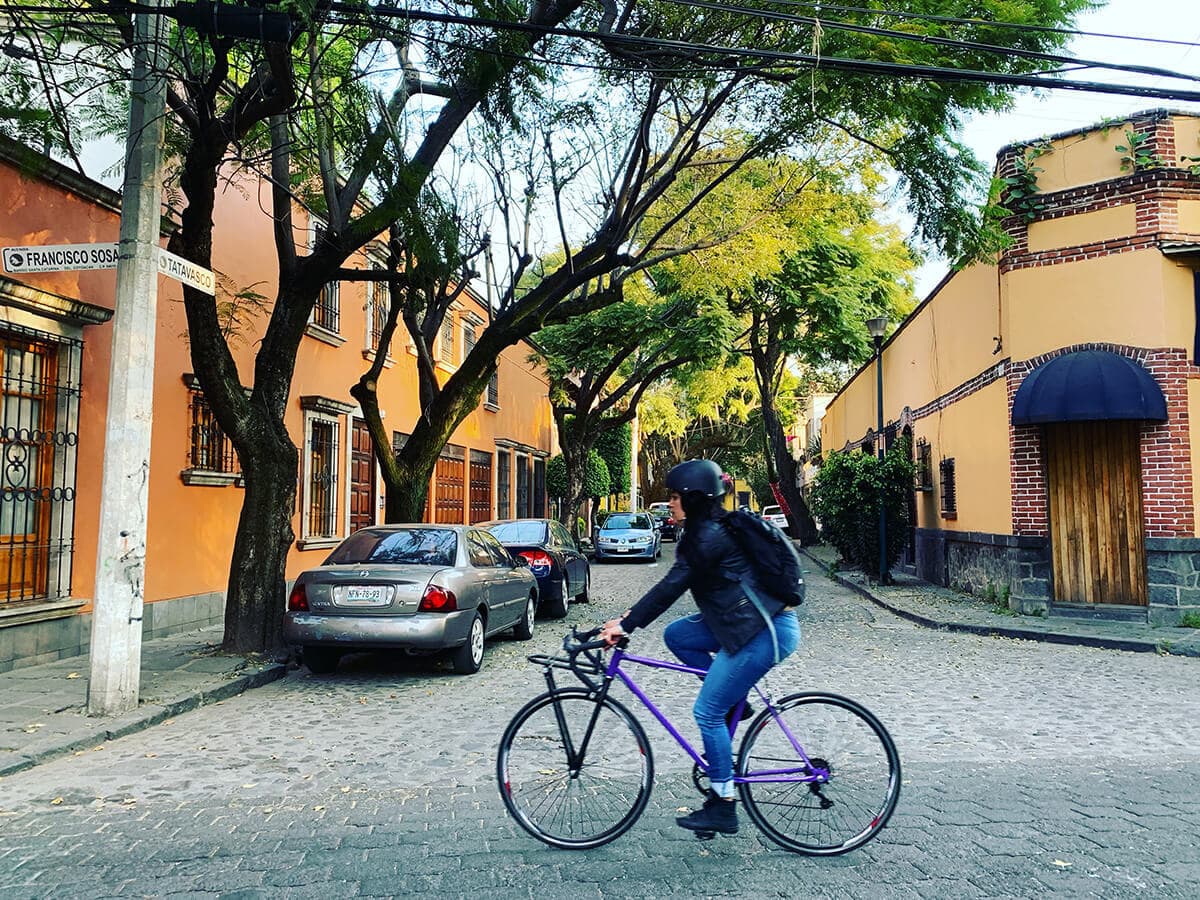 Person riding a bike through a village intersection