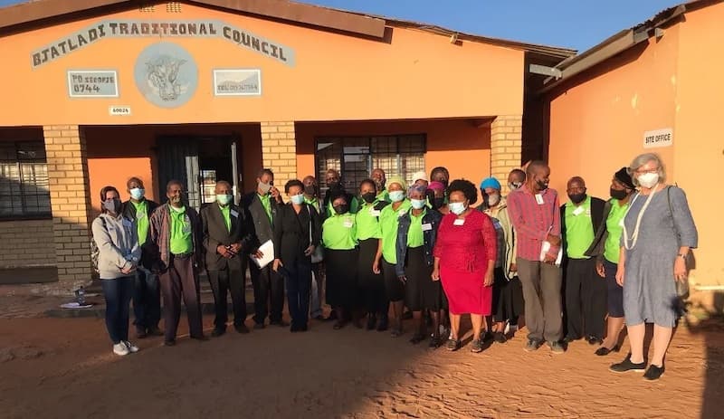 A group of Variant Bio Partners in South Africa pose in front of the Bjatladi Traditional Council building