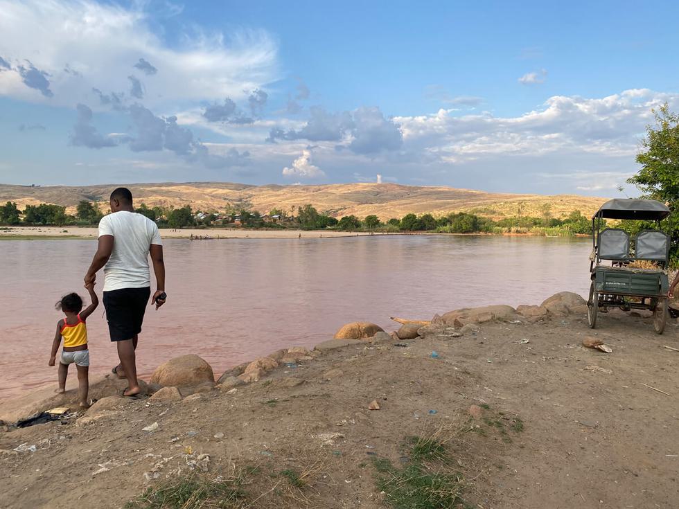 Man and child on a river bank