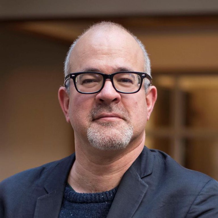 A headshot of Misha Angrist