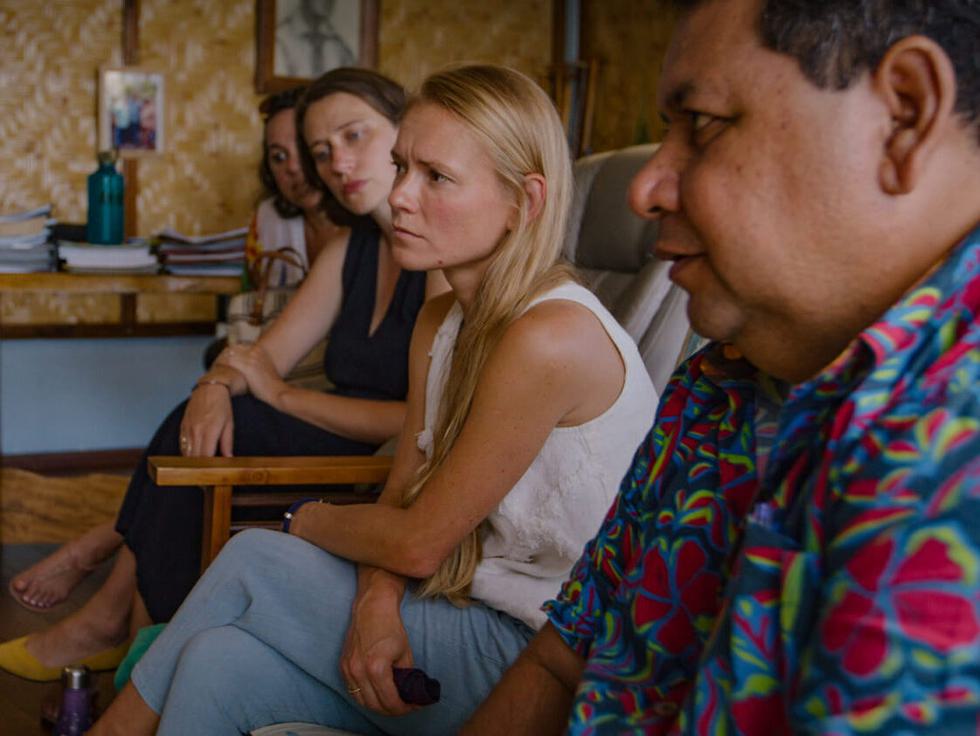 Several people sitting in a room looking off-camera to the left.